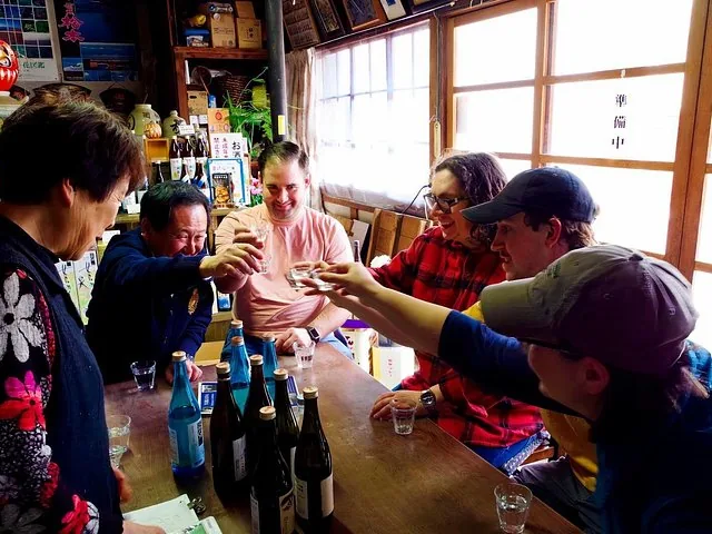 Group of people raising glasses for a toast in a local shop